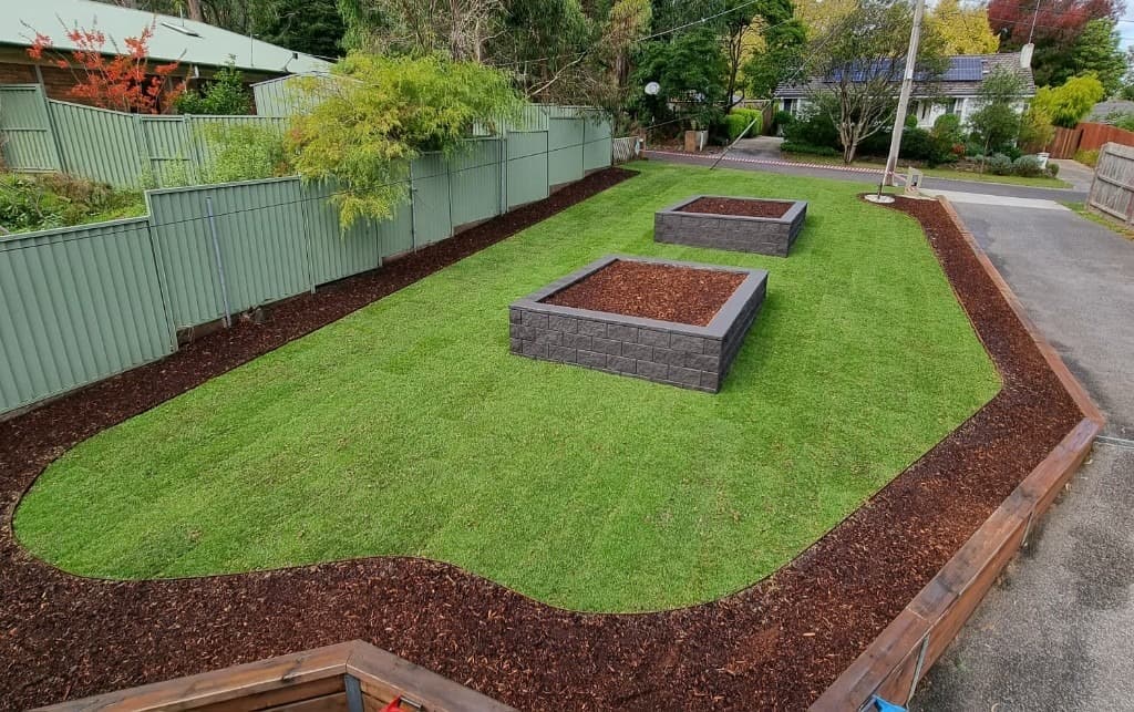 Manicured front yard with sharp lawn edges and raised garden beds