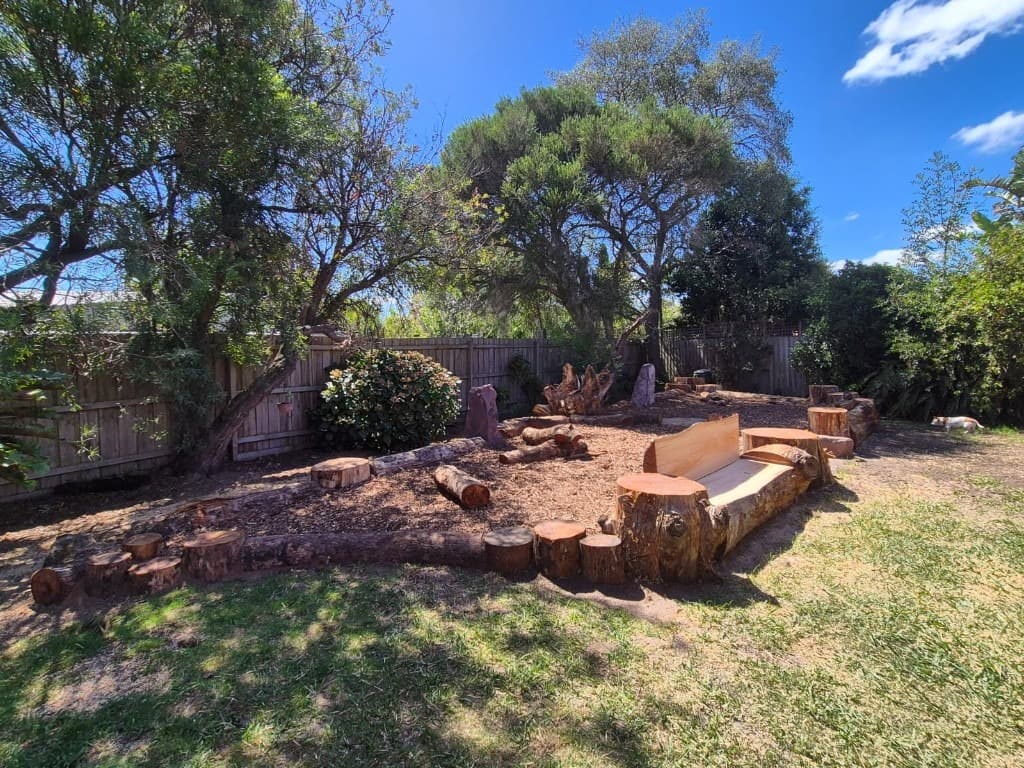 Natural log garden with carved bench and stump seating